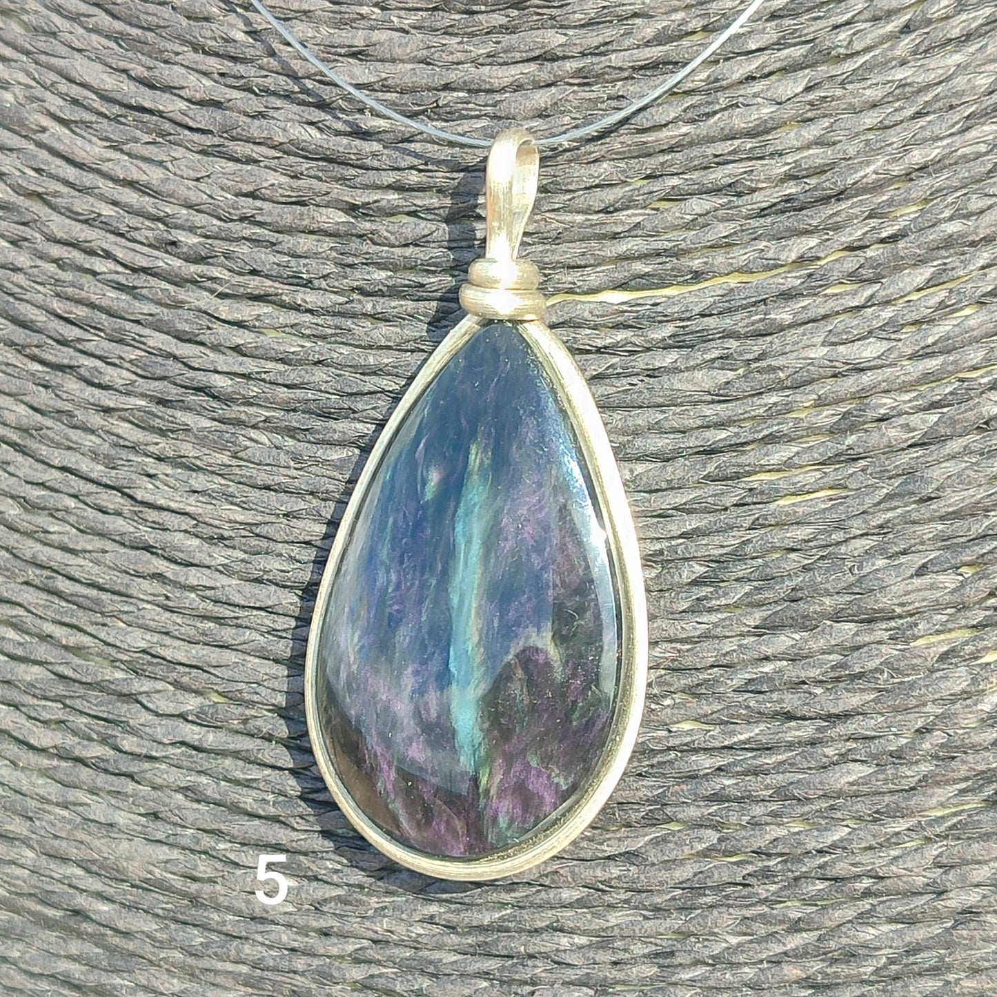 Huichol mantle teardrop obsidian pendant