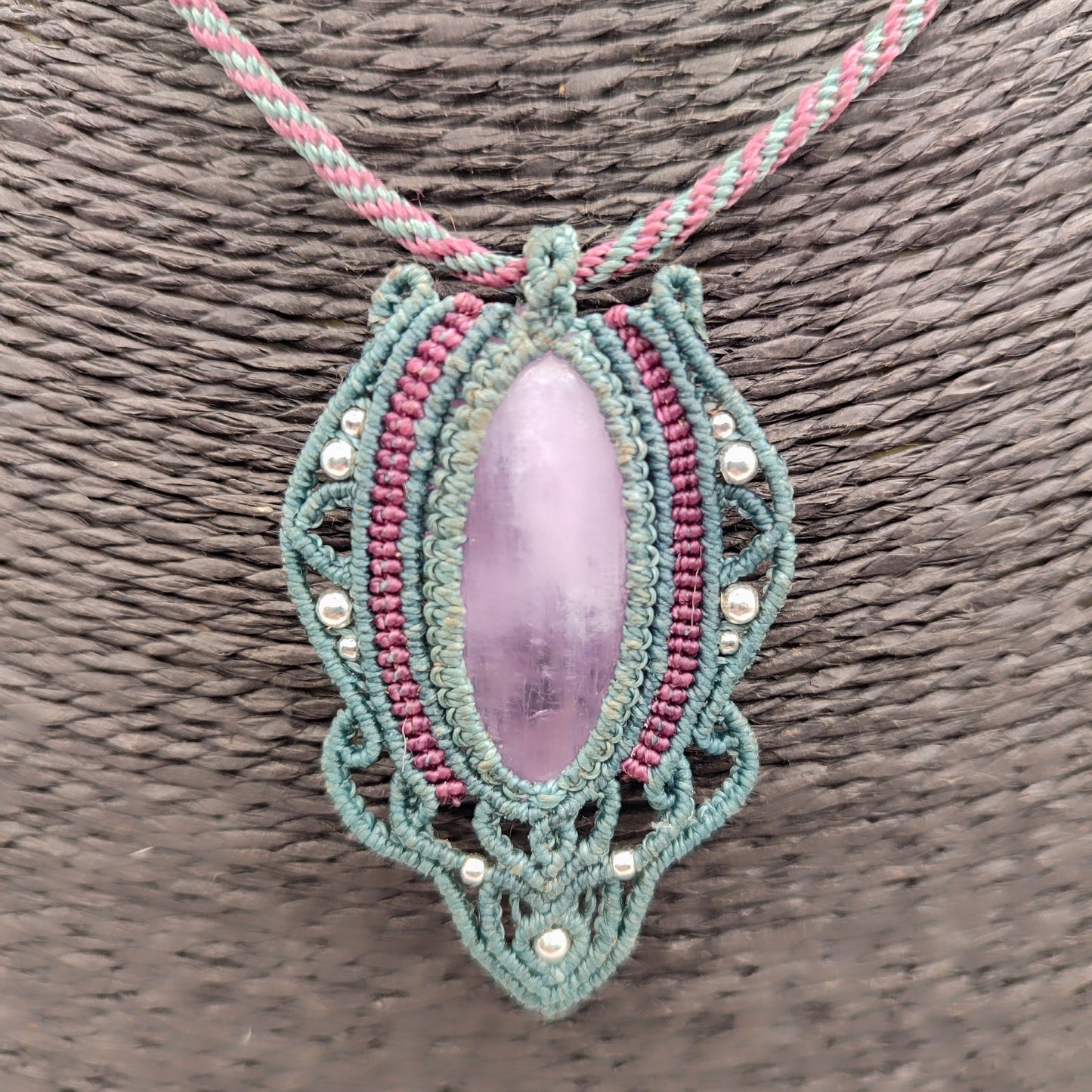 Piedra kuncita natural de color rosa malva engarzada en hilo verde agua.