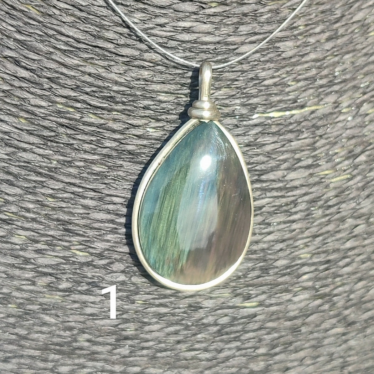 Huichol mantle teardrop obsidian pendant