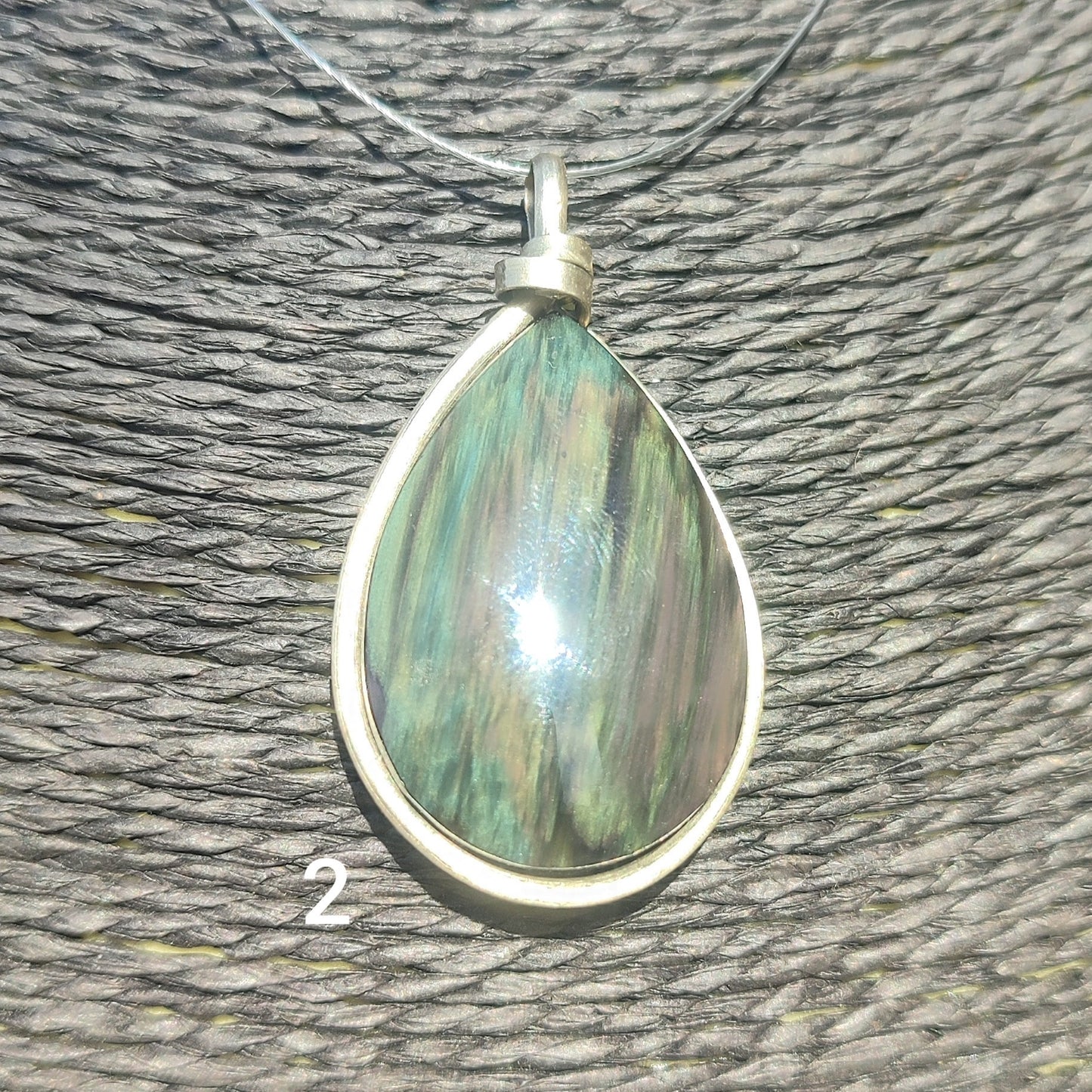 Huichol mantle teardrop obsidian pendant